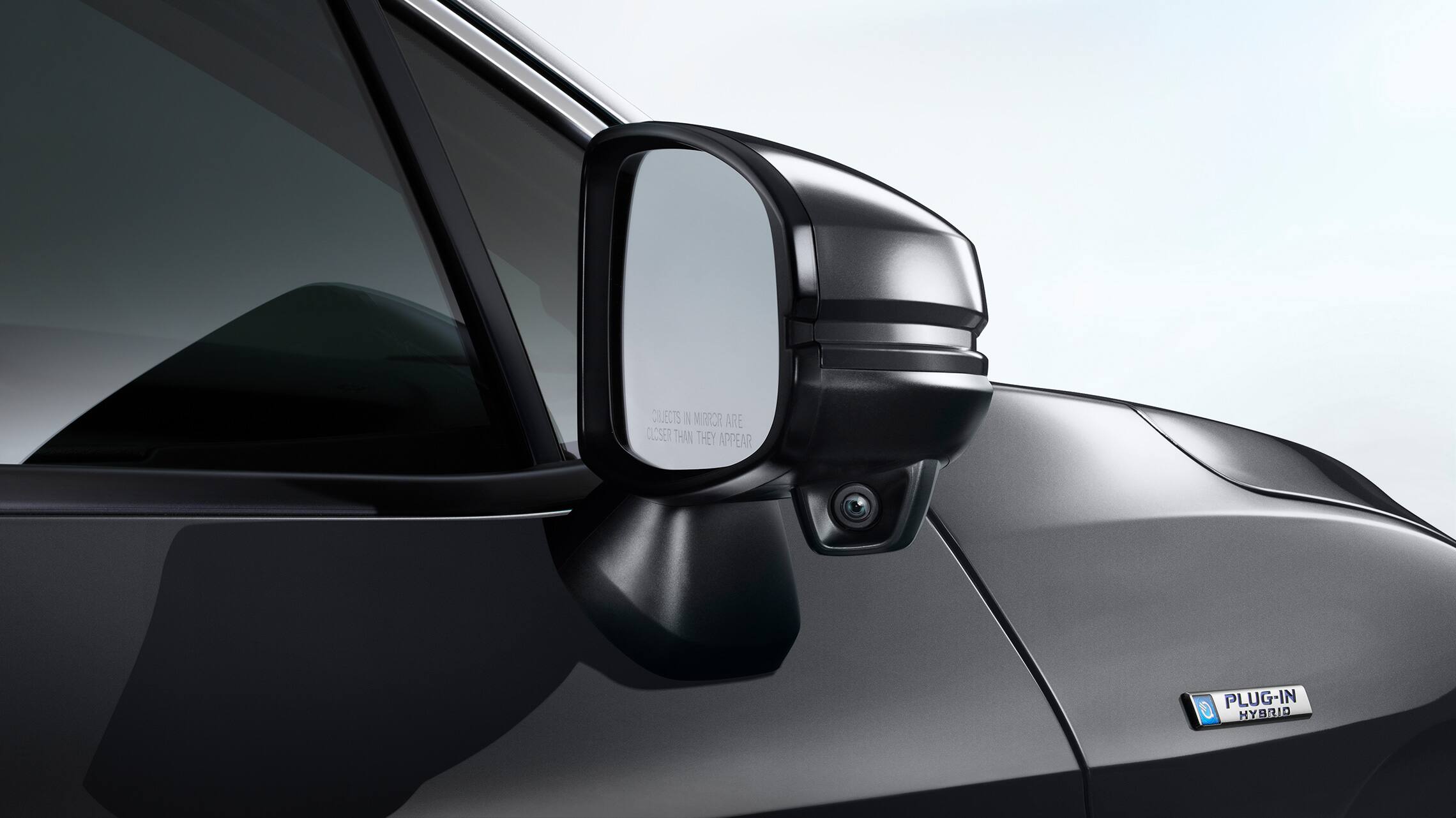 Detail of Honda LaneWatch™ camera on passenger-side mirror.
